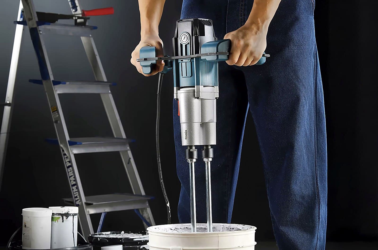 Worker mixing with a Ronix paddle mixer on site